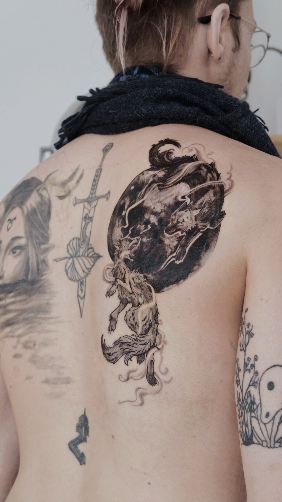 Two wolves and a moon tattoo