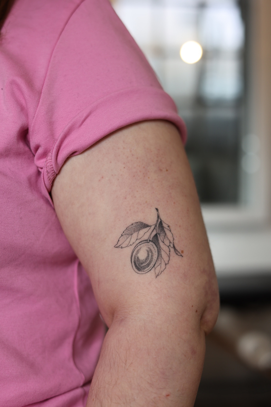 Pflaume Tattoo in Black & Gray style on Upper Arm by Patimonstar Hamburg