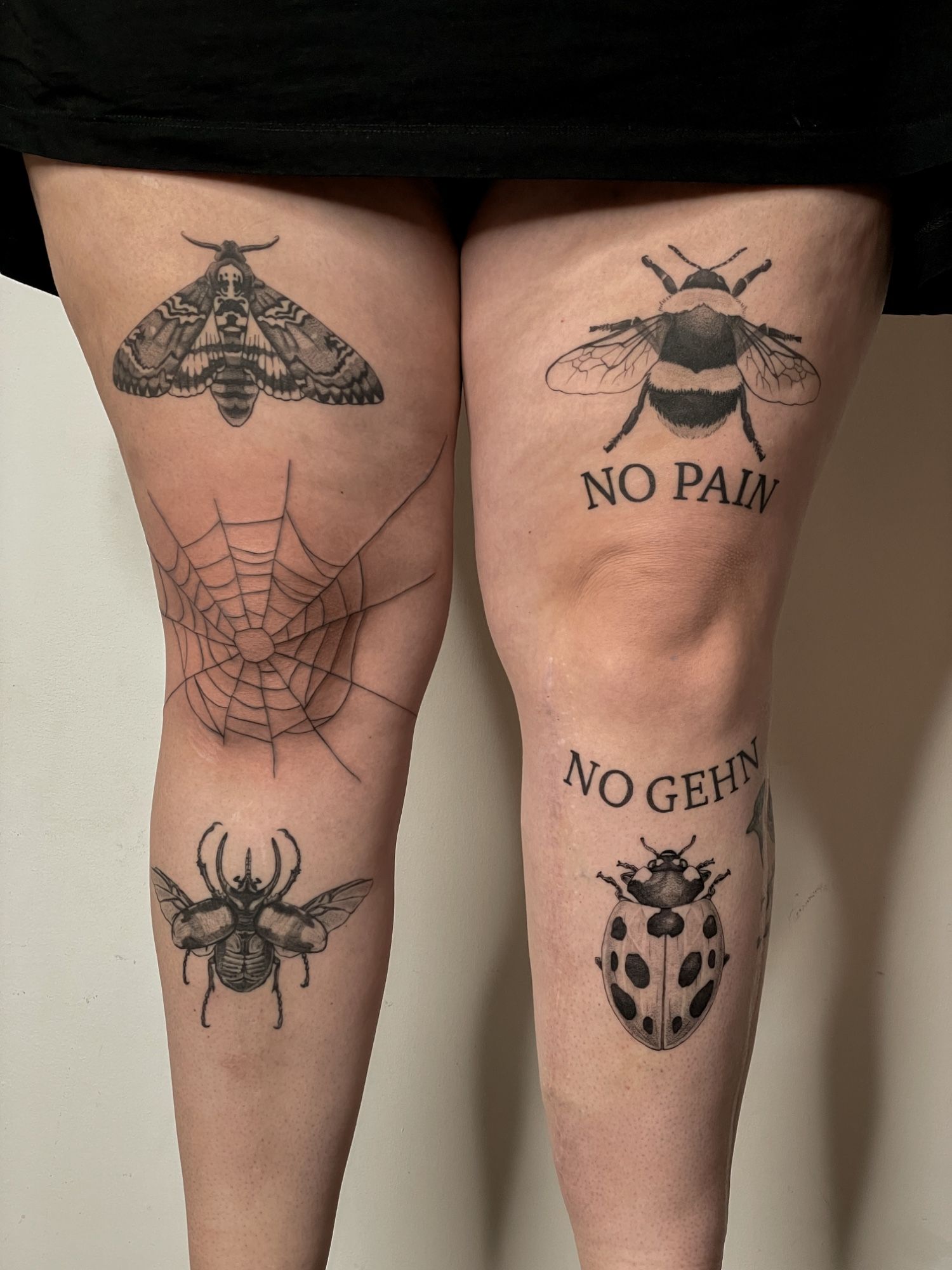 diverse Insekten, Spinnennetz & Lettering Beine im Blackwork Style auf Oberschenkel von Pretty Bold in Hamburg