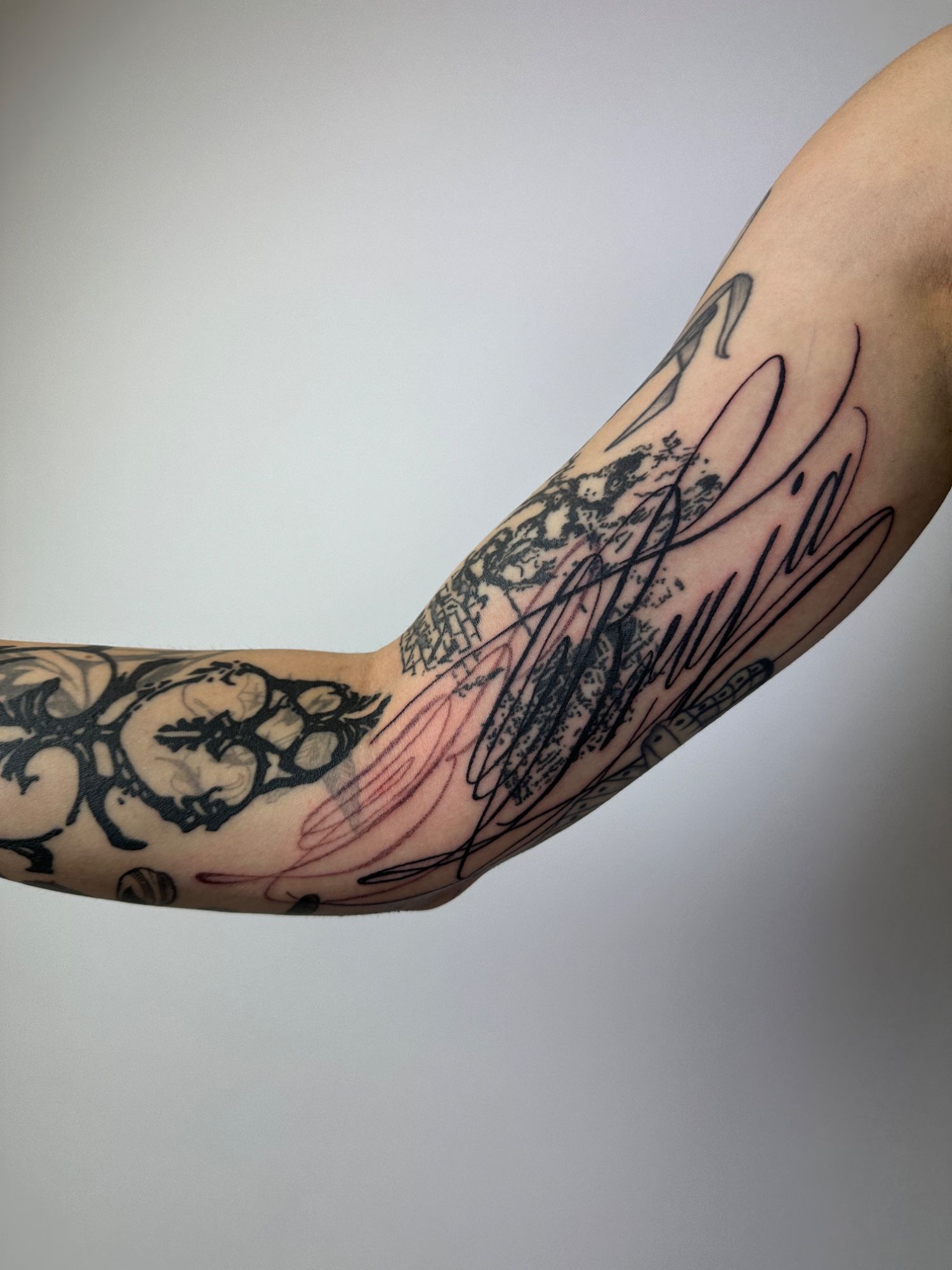 Lettering im Black & Gray Style auf Oberarm von Rougetattoos in Leipzig