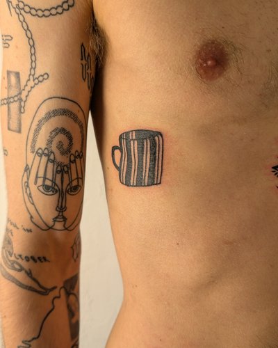 Cozy whimsical Tasse im Blackwork Style auf Rippen von janus_tattoo in Hamburg