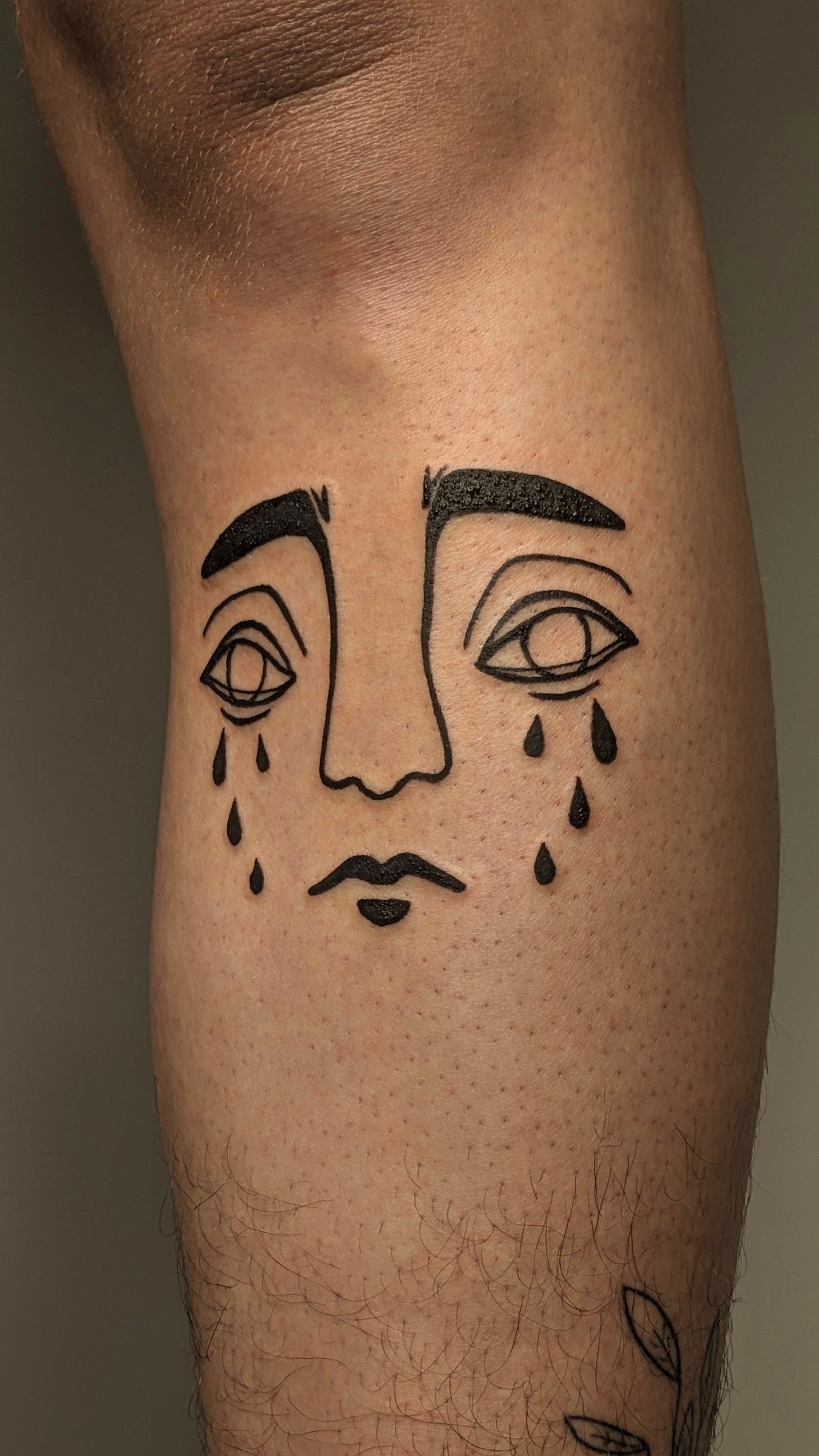 Gesicht x Janus tattoo in Blackwork style on Shin by janus_tattoo Hamburg