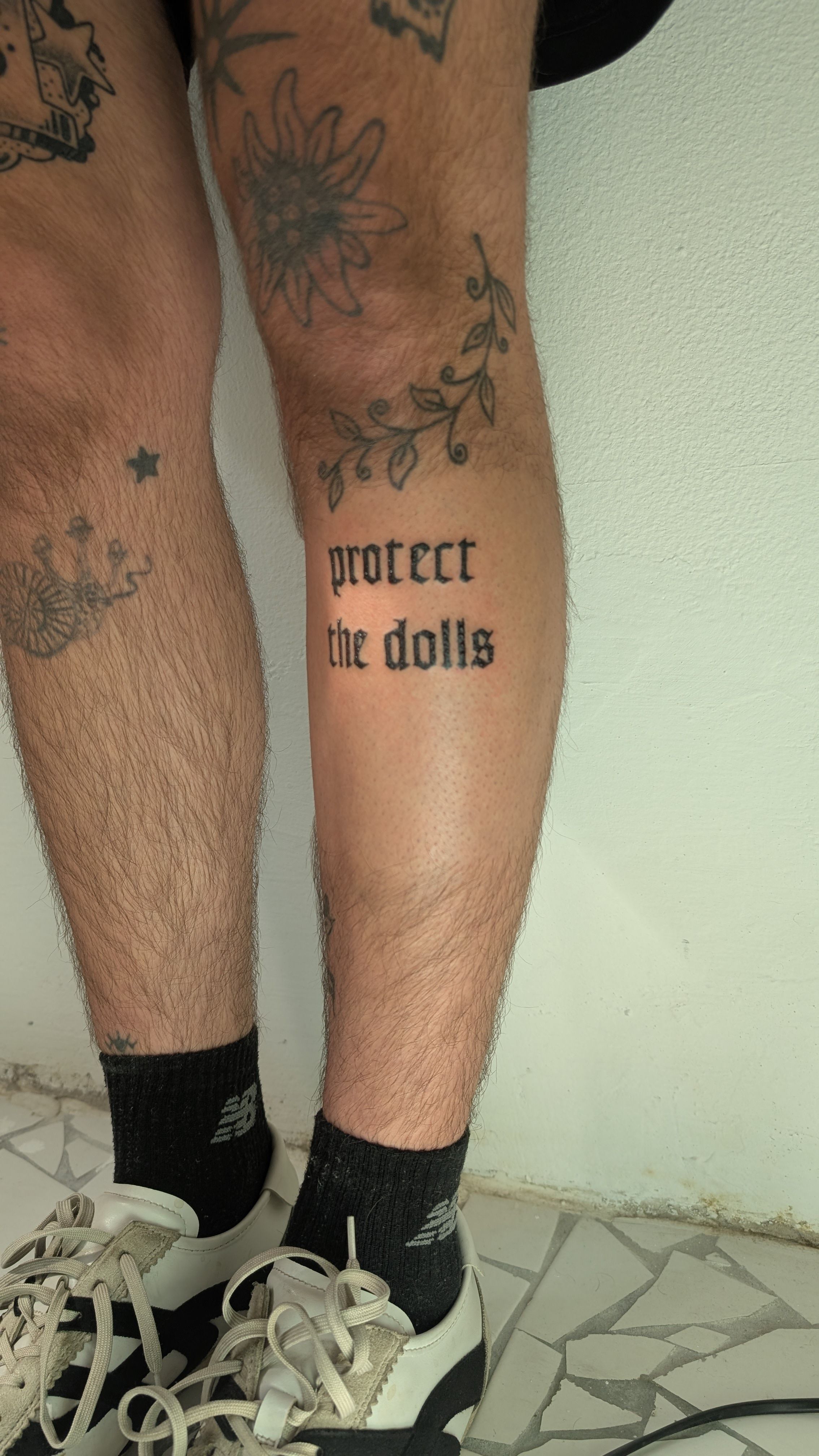 protect the dolls blackletter in Blackwork style on Shin by janus_tattoo Hamburg