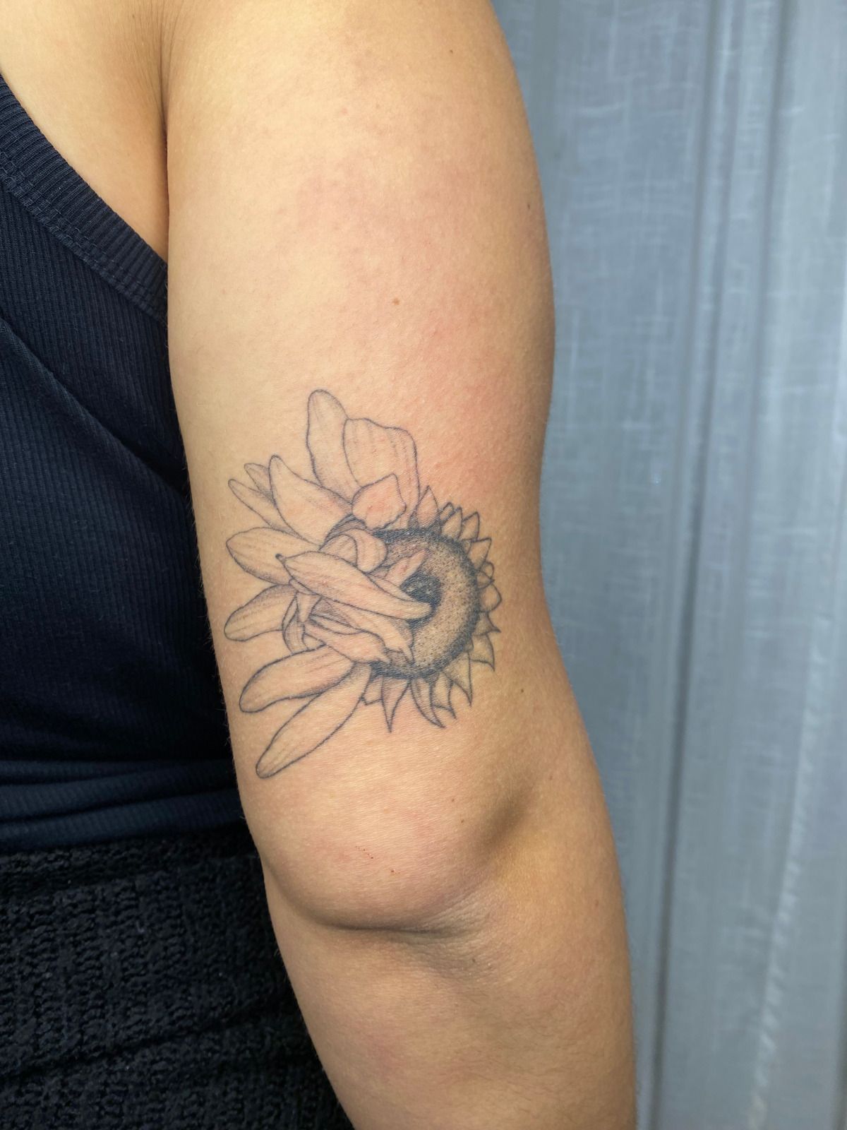 Healed Sunflower in Fineline style on Upper Arm by Sadmeply Tattoo Hamburg