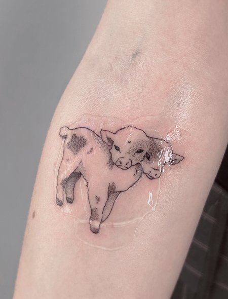 Siamese twin calves in Black & Gray style on Forearm by Atelier tat Leipzig