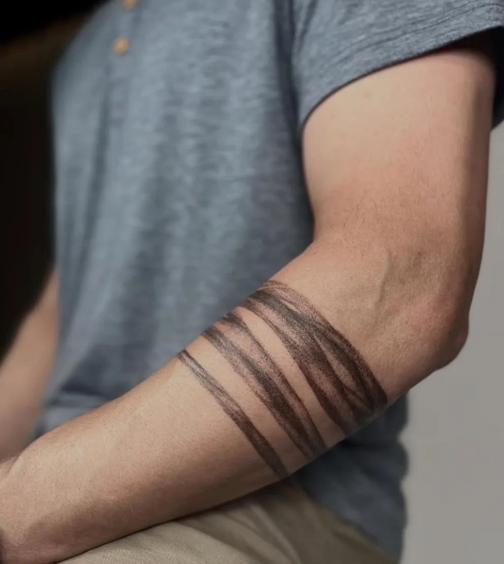 Trash Polka style armring tattoo on forearm
