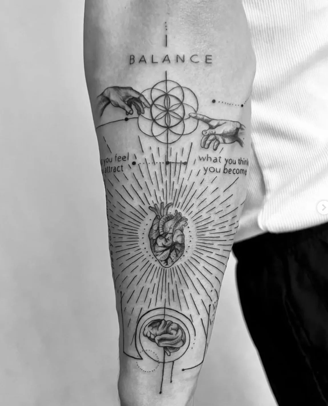 Balance tattoo with hands, flower of life, heart, and brain in fine line style on forearm