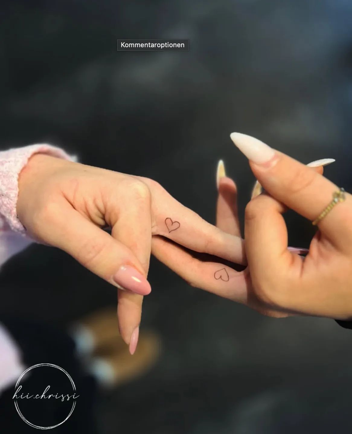 Two fine line heart tattoos on fingers