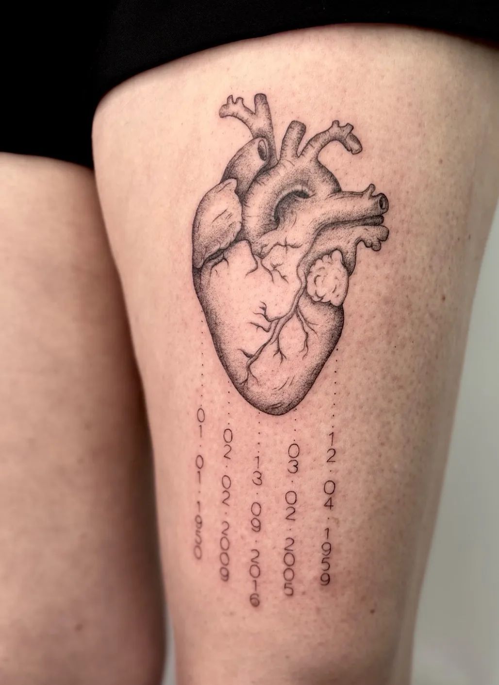 Realistic heart fine line tattoo with dates on thigh