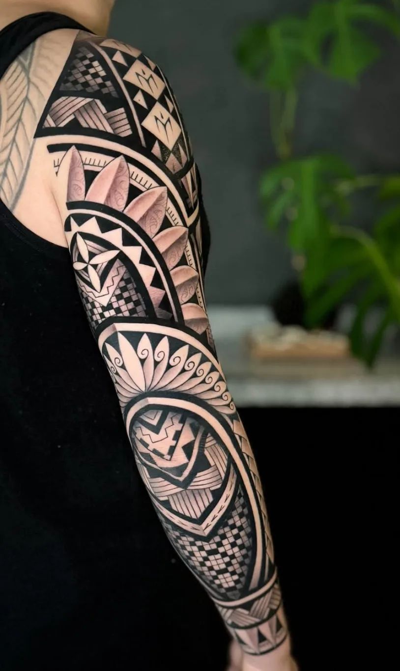 Maori full sleeve tattoo with traditional patterns and shading on arm