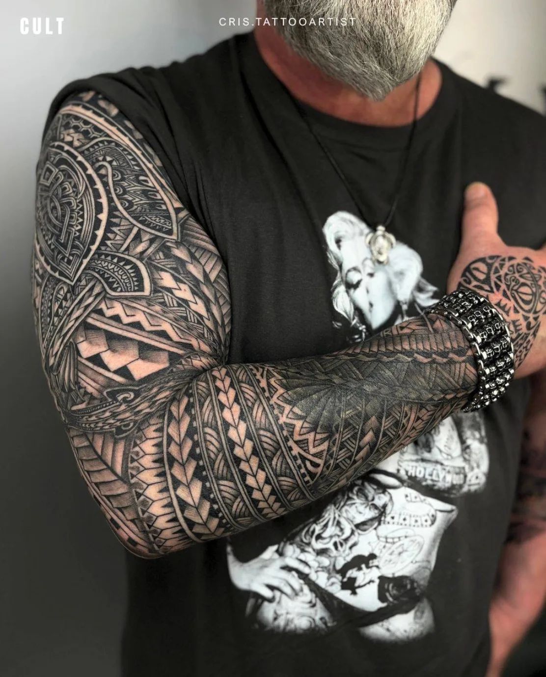 Maori blackwork full sleeve tattoo with geometric patterns and traditional motifs