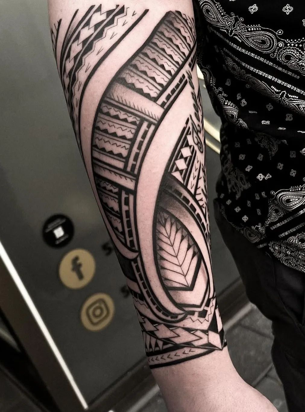 Maori tattoo in Polynesian style on forearm with detailed patterns and shading