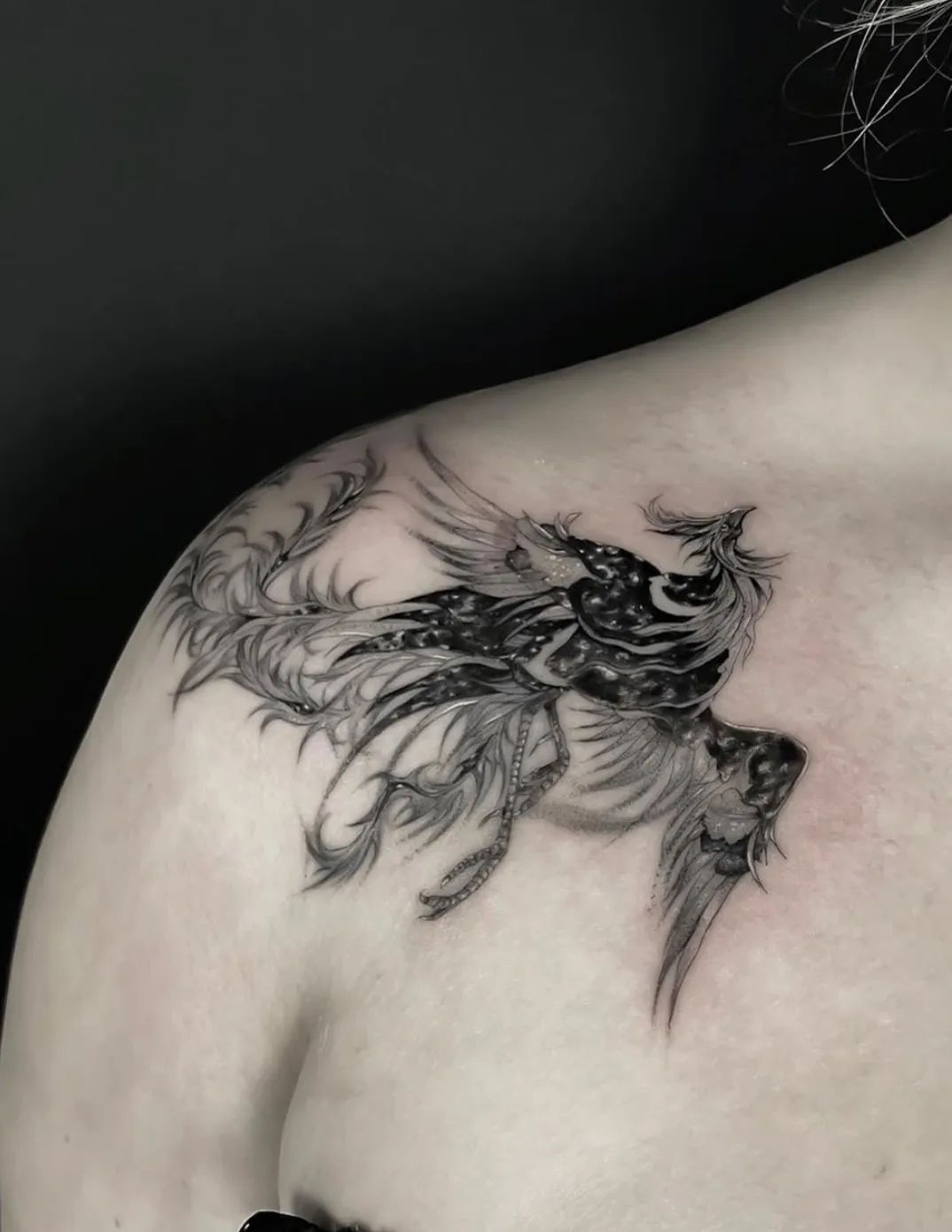 Fine line phoenix tattoo on the shoulder