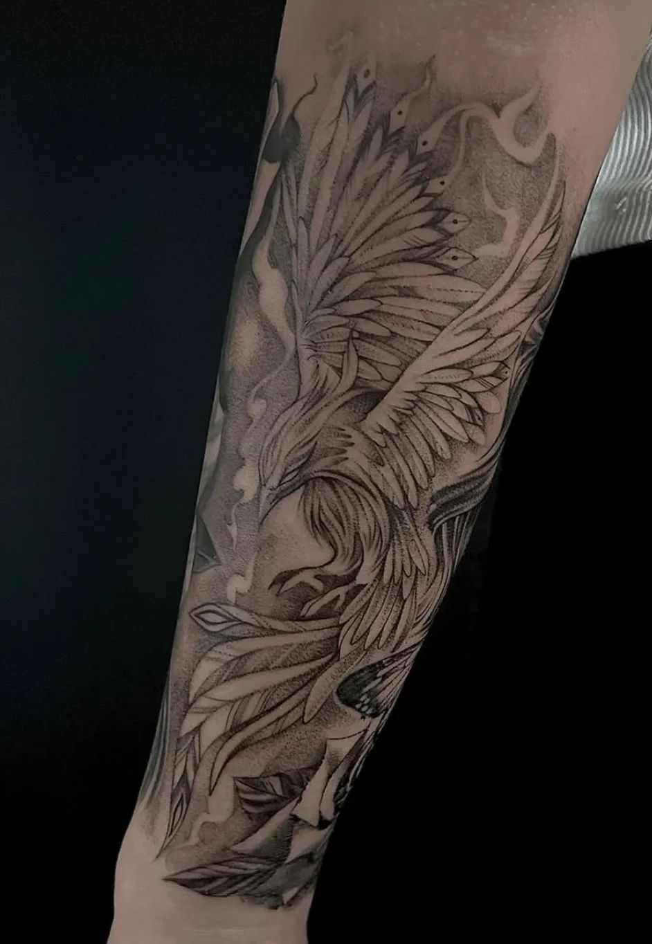 Black and grey phoenix tattoo on forearm