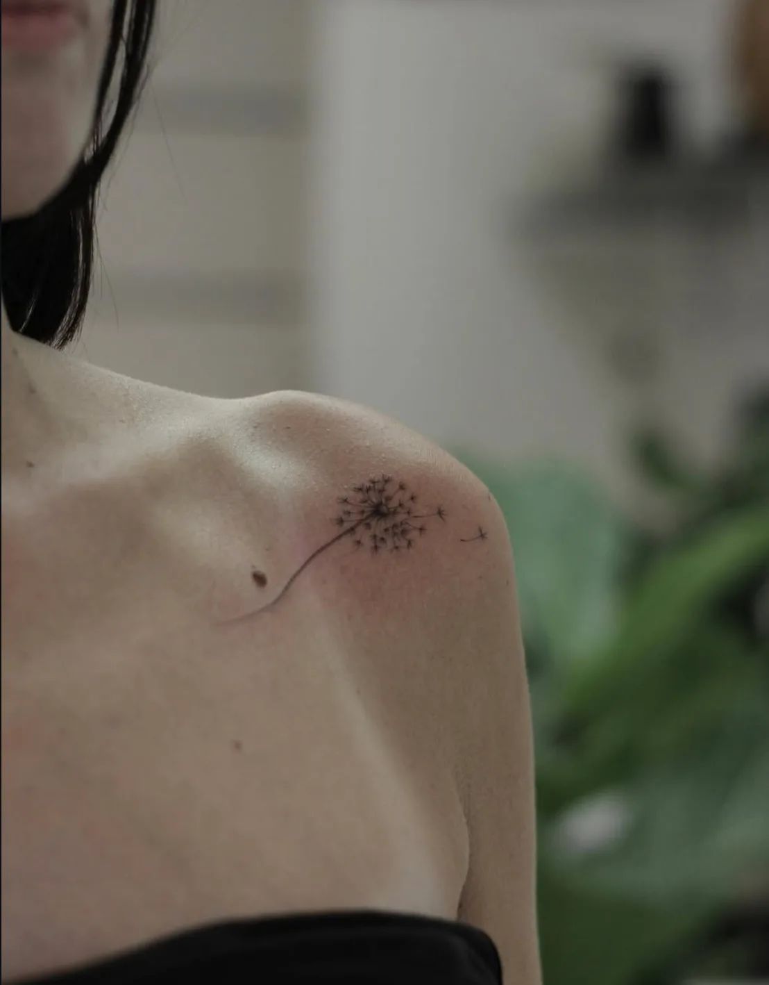 Fine line dandelion tattoo on shoulder