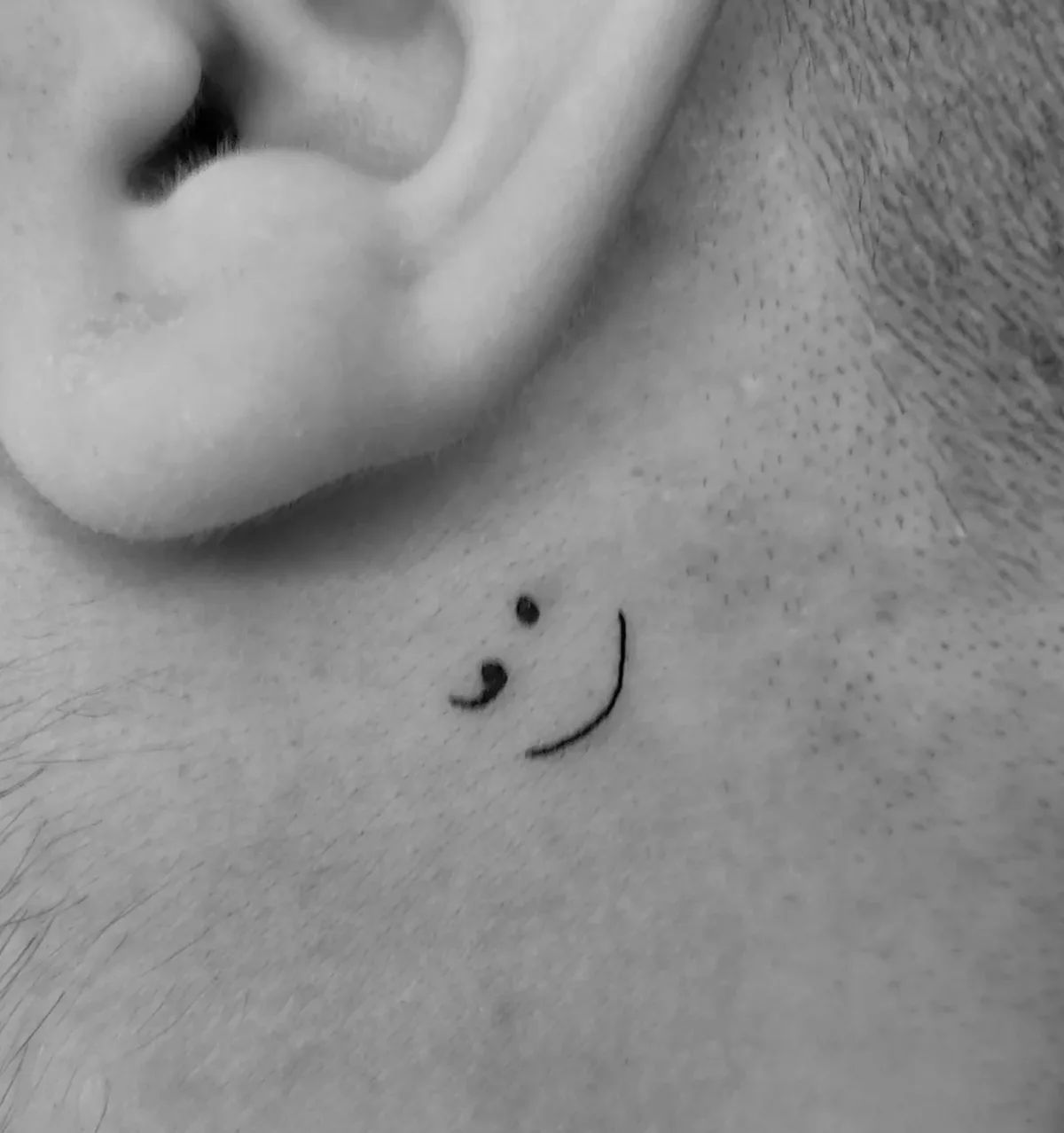 Fine line semicolon tattoo behind the ear