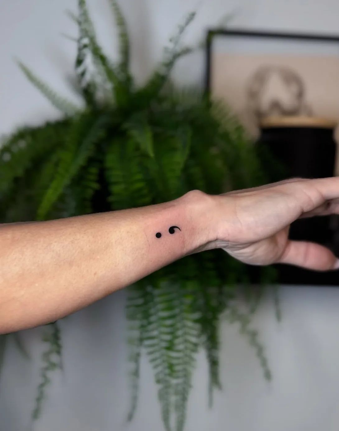 Fine line semicolon tattoo on wrist