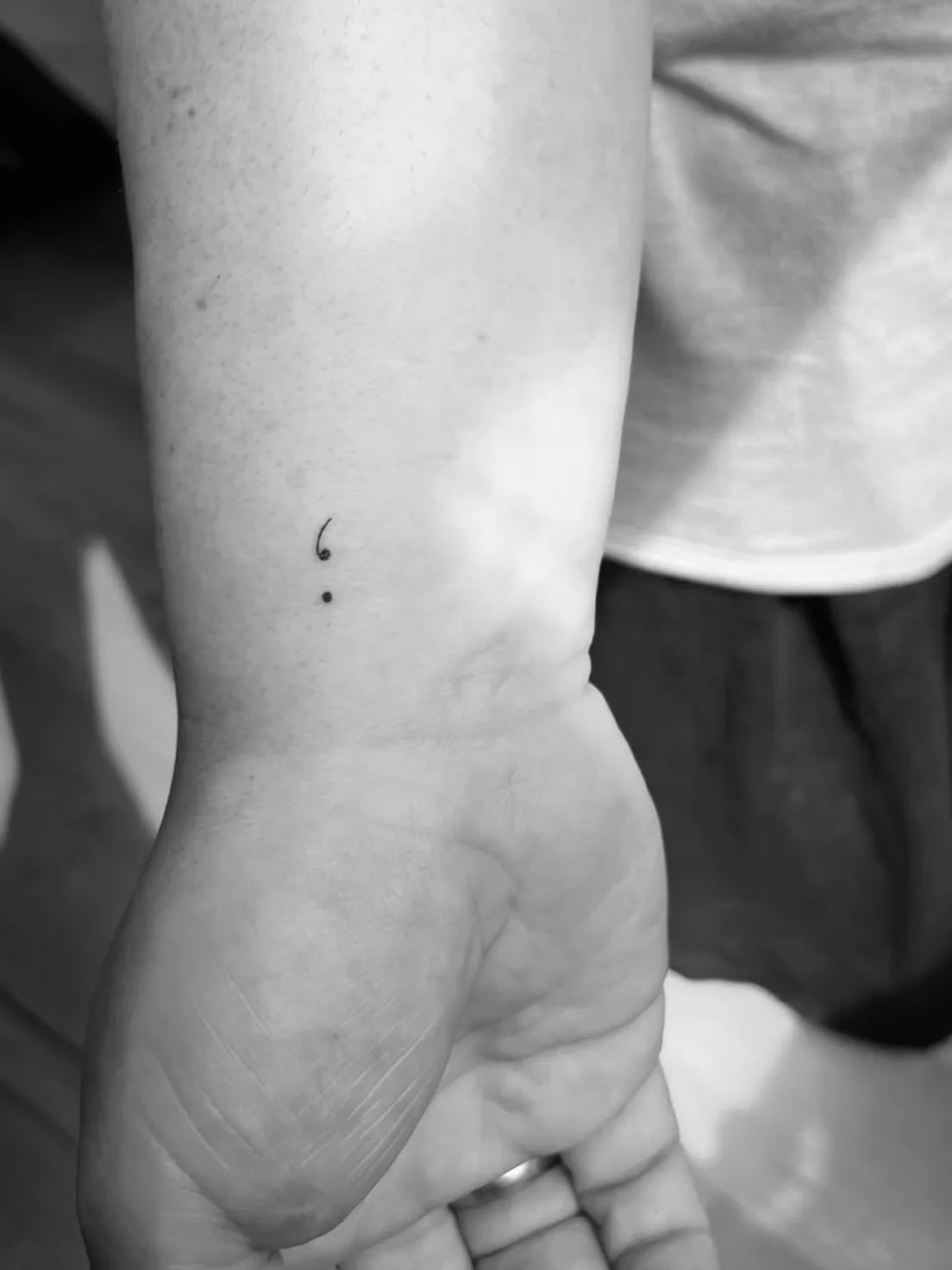 Fine line semicolon tattoo on wrist