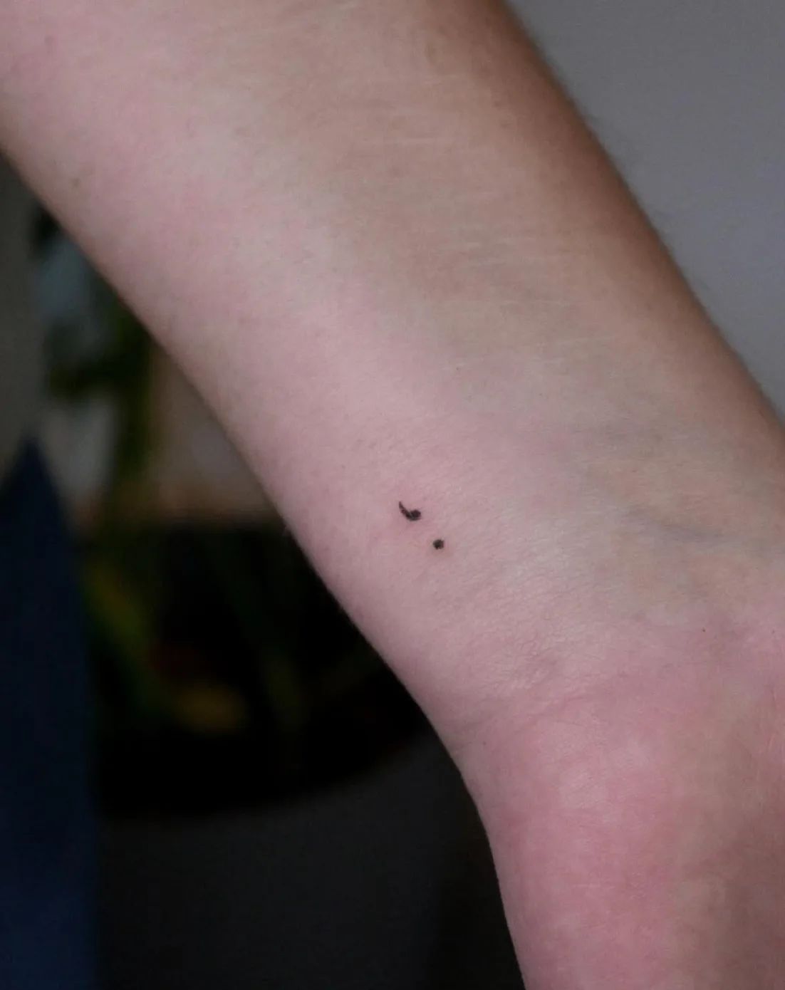 Fine line semicolon tattoo on wrist