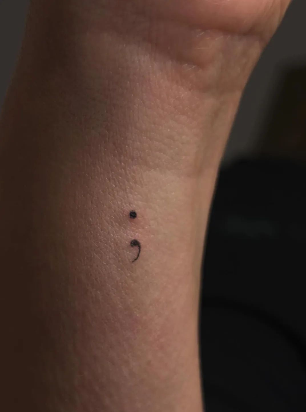 Fine line semicolon tattoo on wrist